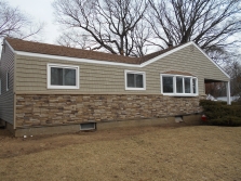 After - New siding, windows, and gutters